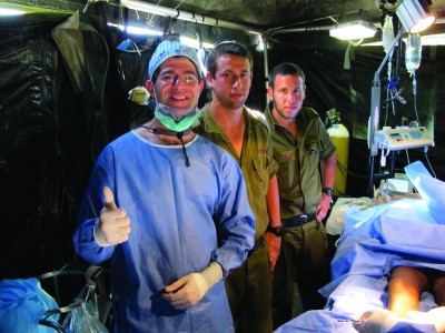 Perlyn with Israeli soldiers assisting him during a surgery.