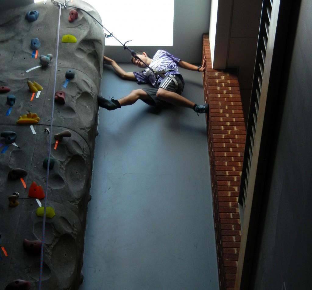 Sophomore Neil Docherty climbs the 'chimney' at the Clayton Center climbing wall.  The Basic Climbing Class is taught by Eric, an employee of the Upper Limits climbing gym in downtown Saint Louis.