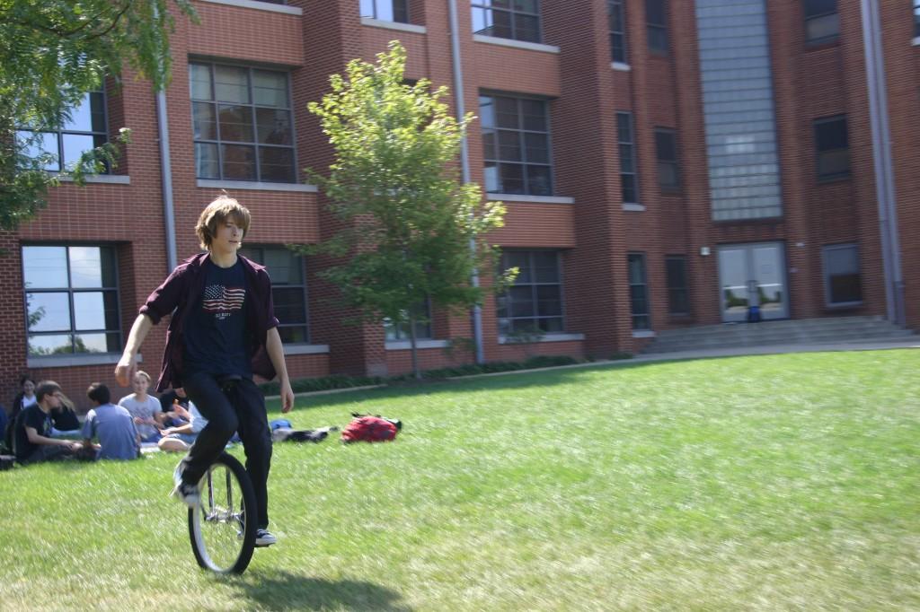 Junior Greg Dallas rides his unicycle in the Quad. (Madeleine Fleming)