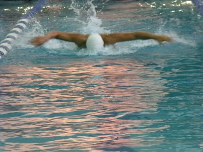 A swimmer comes up for air during a butterfly stroke in a race. The butterfly stroke is the most difficult stroke to master, but one of the most graceful strokes when performed correctly. (Thalia Sass)