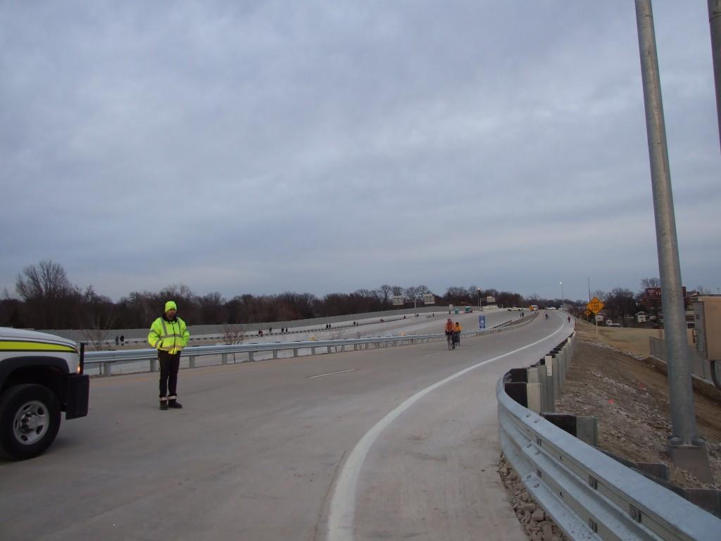 A highway worker stands at the entrance to the new Highway 40.  On Sunday, pedestrians and bikers were allowed to walk and bike on the new portion of the highway in celebration of its opening today. (Elizabeth Sikora)