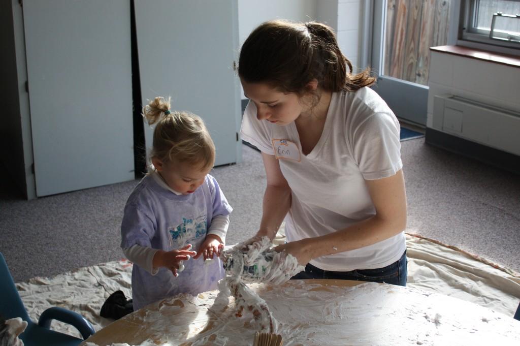 Senior Erin Murray plays with a child at the Family Centers' annual "Messy Play." This event was organized by the CHS Community Service Club and many students took part. (Caroline Stamp)