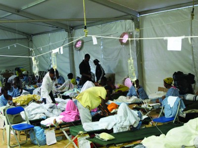 Victims of the earthquake receive treatment and refuge in a hospital tent.