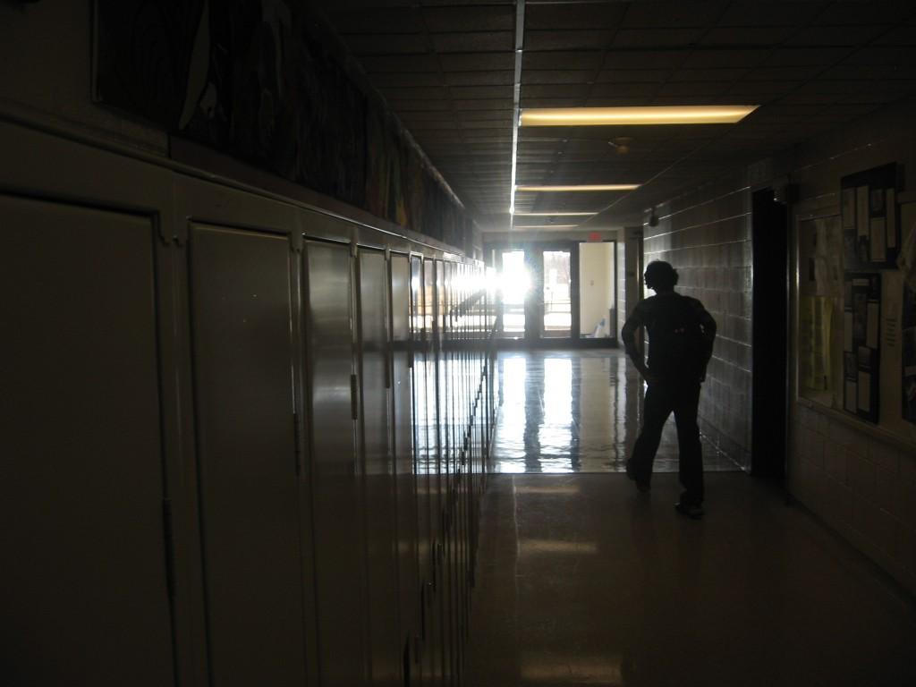 Part of a Digital Photo II class project, a student walks into the light to show an interesting angle.  (Jake Leech) 