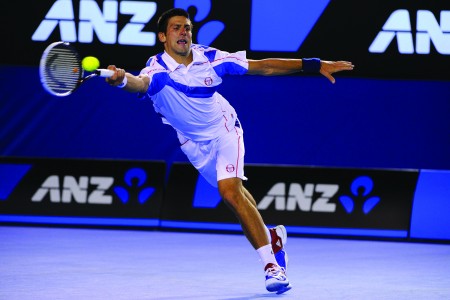Serbiaâ€™s Novak Djokovic hits a forehand shot to Switzerlandâ€™s Roger Federer during their menâ€™s semi-final match of the Australian Open tennis tournament at Melbourne Park in Melbourne. Djokovic won, 7-6, 7-5, 6-4. (Corinne Dubreuil/Abaca Press/MCT)