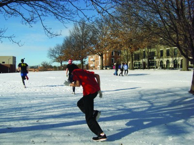 Junior Matthew Millet runs in the snow after school with other members of winter running club. Members look to stay in shape between sport seasons to upkeep their levels of performance throughout the year. 