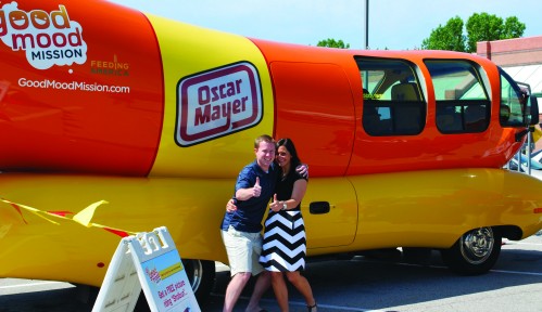Kirk smiles with an enthusiastic fan in front of the Wienermobile during a publicity event, which he was also in charge of organizing. (Courtesy of Zach Kirk)