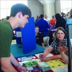 Senior Joseph Dillon listens intently to a representative of one of the many nonprofits that presented at the 2010 fair. Various kinds of volunteering opportunities were presented at last yearâ€™s St. Louis Volunteen Fair.  (Jake BErnstein)