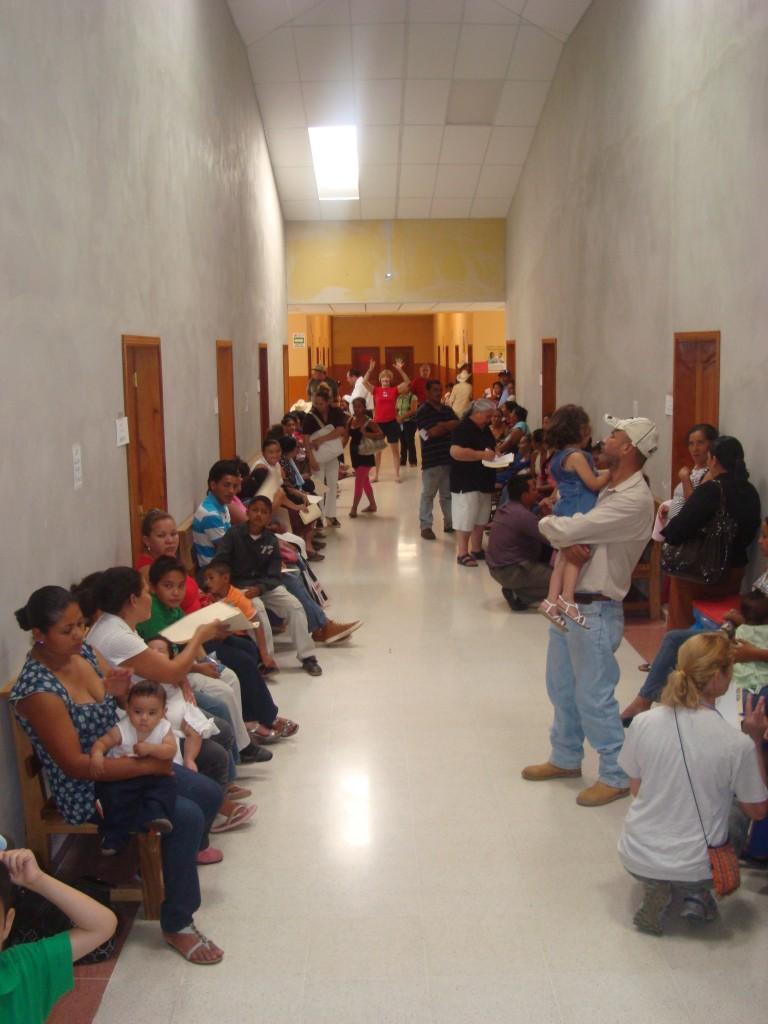 Townsfolk from the small and poor town of Catacamas, Honduras, line up as they wait for an appointment with a pulmonary and neurology brigade from the United States.
