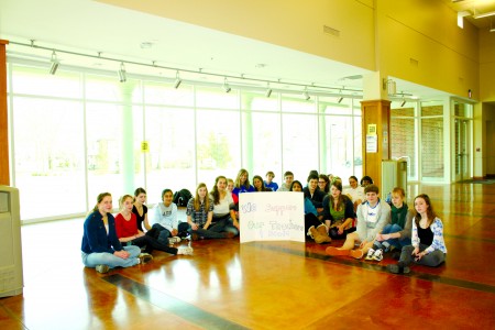 The group of Ladue students who organized the rally showing their disapproval for the layoff of Ladue teachers pose for a picture with a sign that says â€œWe Support Our Teachers and Staff.â€