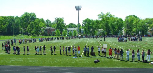 Students join hands as they encircle Gay Field. Protest leaders, such as Chase Haslett and Wolfy Gaidis, aimed to maintain a peaceful atmosphere. Once they commanded the attention of students, the leaders instructed the crowd to remain cooperative.