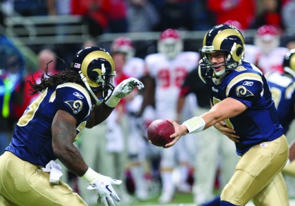 Sam Bradford hands the ball off to Steven Jackson, the Ramsâ€™ running back. Bradfordâ€™s presence and accuracy in the pocket last season has set the Rams on the right track to return to their former winning glory.