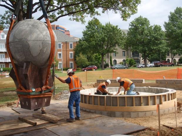 Workers slowly move the Globe to its new location in Centennial Plaza, across from the front entrance to the school.