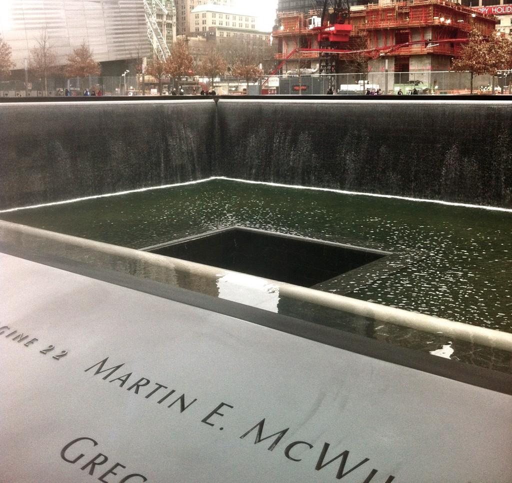 This is a photo of the new 9/11 memorial in New York City. This memorial displays the two imprints of the twin towers and displays the names of those who died on 9/11. It is a vast and magnificent memorial. 