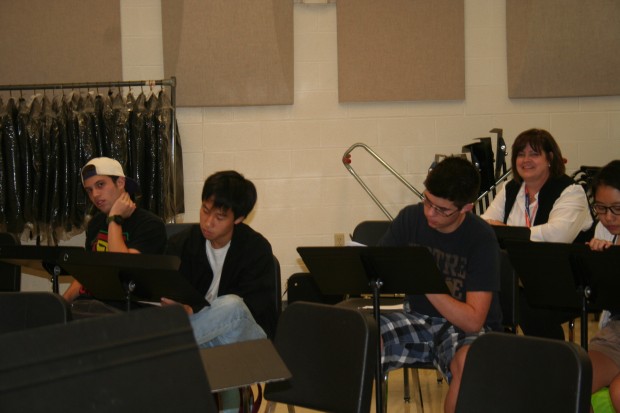 Left to Right: CHS Tri-M members Jeremy Glik, Daniel Fan, Isaac Ilvicky, Hanna Park, and Tri-M advisor Julie Hoffman jot down their thoughts on a musician's performance in the orchestra room.  On Sept. 18 and Sept. 24 Tri-M had its audition to accept more members.  Photo by Shiori Tomatsu