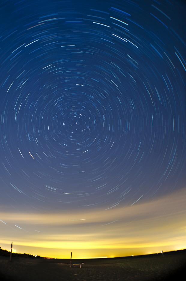 Taken with an open shutter over the course of 15 minutes, this picture shows the stars set over the night sky in Rehoboth Beach, Delaware. A cool naturally occurring phenomenon: all the stars in the sky seem to move around Polaris (the North Star) as the Earth spins. This results in the concentric circle pattern made by the stars. Photo by William Wysession.
