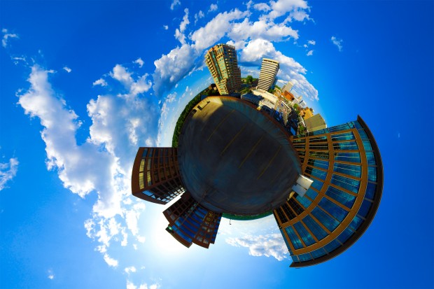 A polar panorama of downtown Clayton on a bright cloudy day. Viewed from a tall parking garage, this image is actually a compilation of 39 different images converted into a stereographic format. Photo by William Wysession.