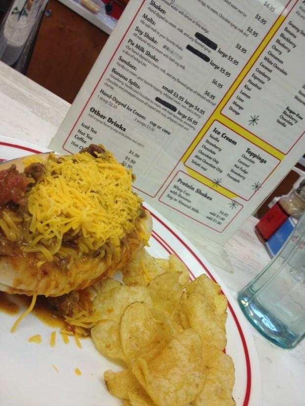 A chili dog and chips.  In the background you can see the dessert menu.