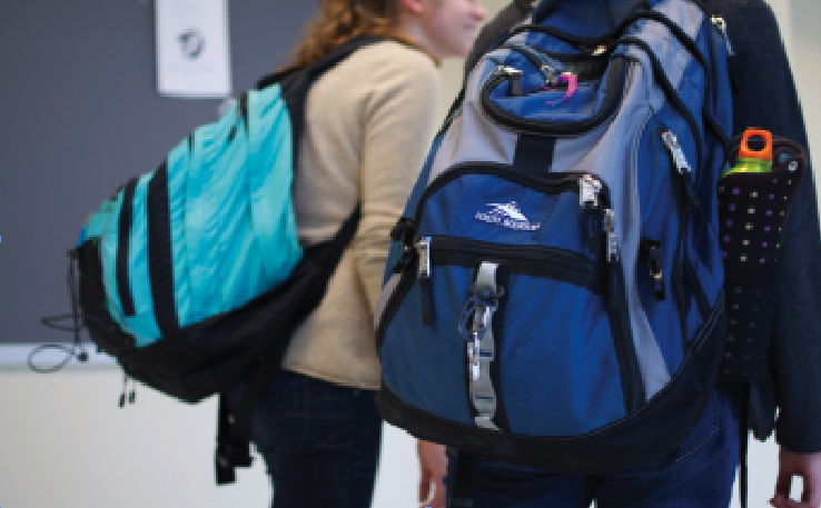 Juniors Alessandra Silva and Abbie Kohmetscher roam the hallways with their seemigly over-sized backpacks. (William Wysesssion)