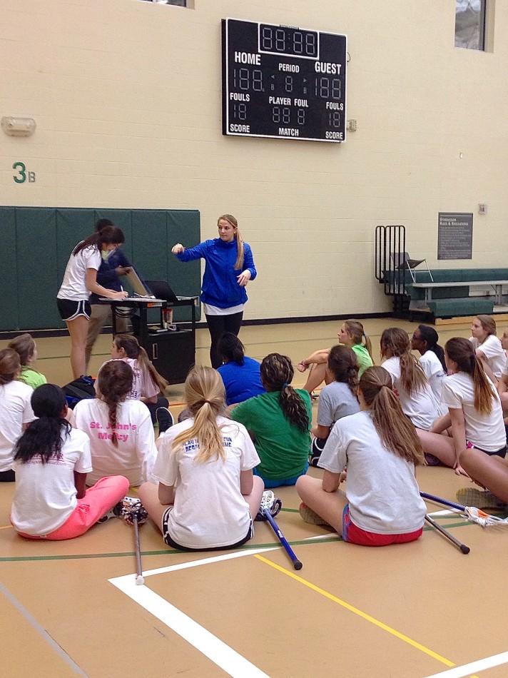 Head coach Darby Hogan talks to the new players on the team at the first practice of the season. 