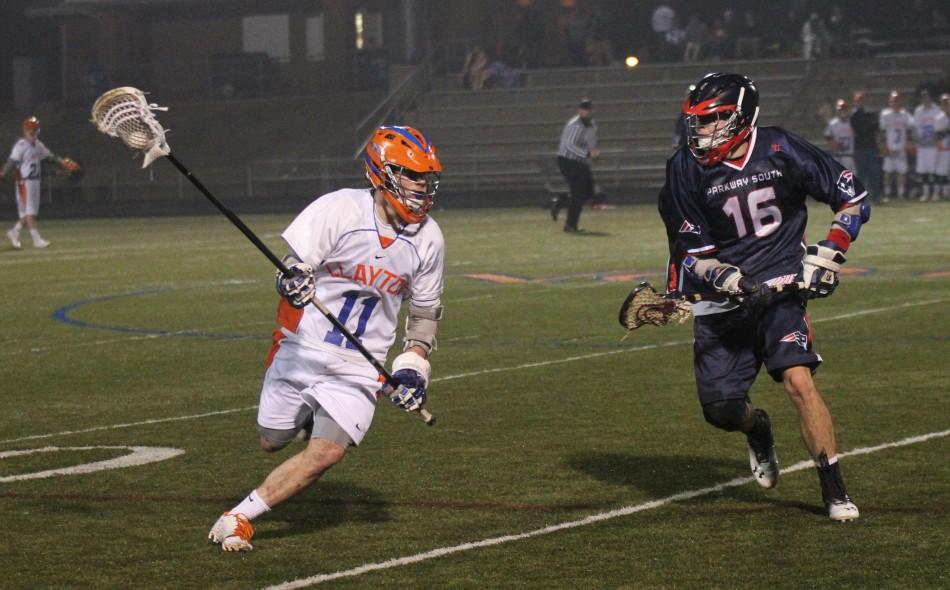 Defenseman Adam Lopata (Junior) carries the ball downfield at Gay on Saturday, March 9th. The Hounds took on Parkway South in the first game of the season under the lights. With a tie game at the half, Clayton came back with a big win. Final: Clayton 13  Parkway South 8
(Photo by Patrick Butler)