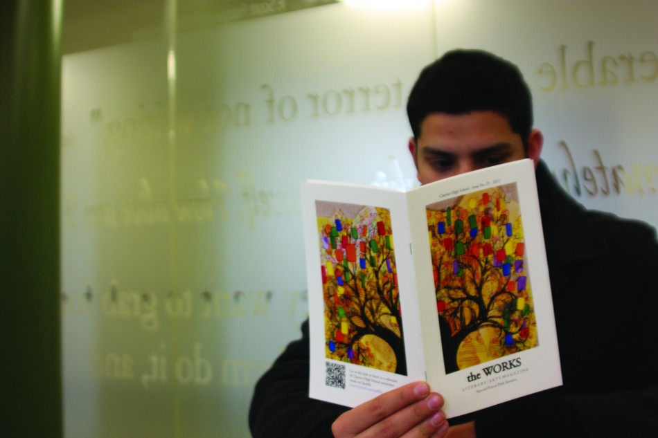 Senior Ketan Jain-Poster reviews the 2013 edition of the CHS literary magazine, The Works. The Works is nominated for the Pacemaker Award. Photo by Rebecca Stiffelman.