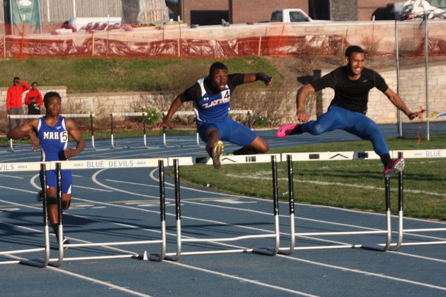 In this photo the Clayton Greyhound's 300 meter hurdle runner leaps the second set of hurdles in a dead heat race to the finish line. Support both the boys and girls track teams at their next meet at home on April 23rd. 