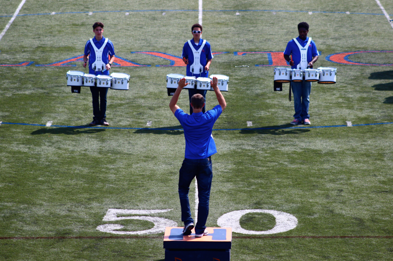 Senior Christopher Longman leads percussion in the halftime show of the Homecoming game.