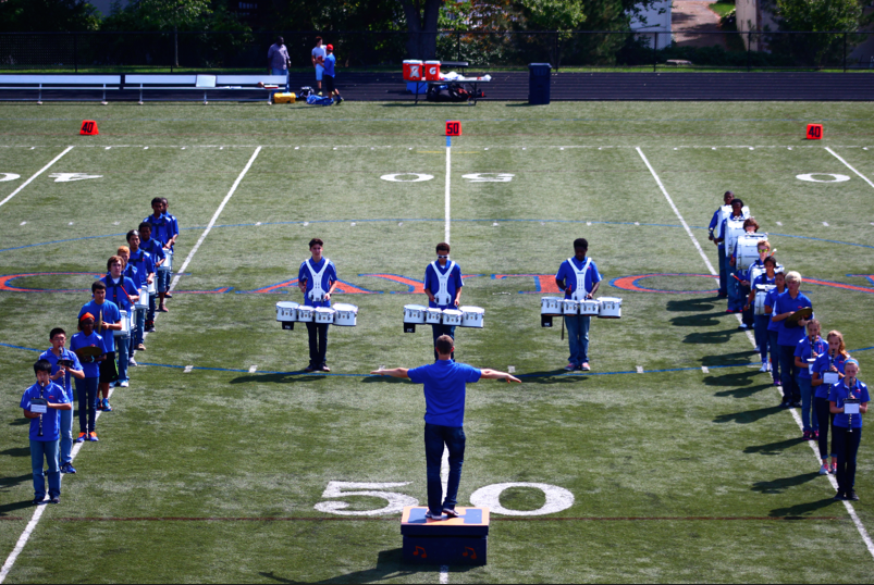 Senior Christopher Longman leads the band during halftime. 