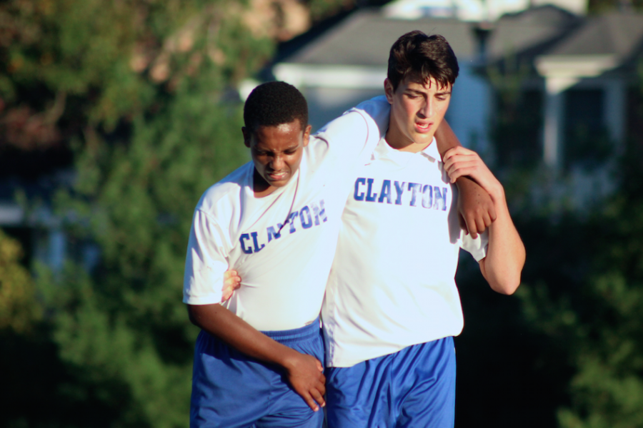 Junior Sevi Michelson helps injured teammate off the field.