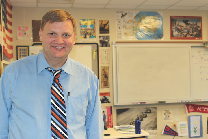 Paul Hoelscher stands in his history Classroom. Hoelscher is a history teacher at CHS and the social studies coordinator for the district (Photo by Gwyneth Henke). 