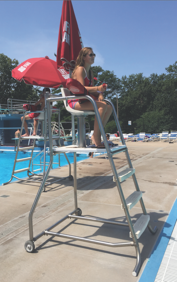 Brown twirling her whistle while watching the pool. 