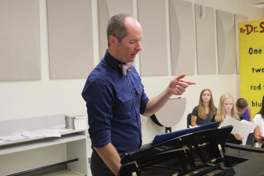 Mr. Price is teaching one of his classes, concert choir.