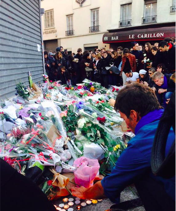 People surround the sites of the attacks with flowers, notes, and candles while mourning those who were lost. 