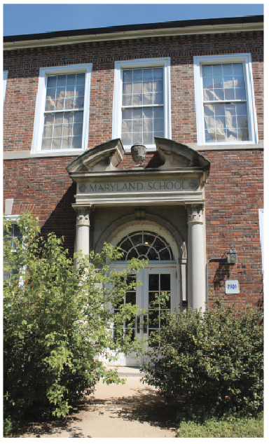 Boarded windows and overgrown vegetation at the Maryland School.