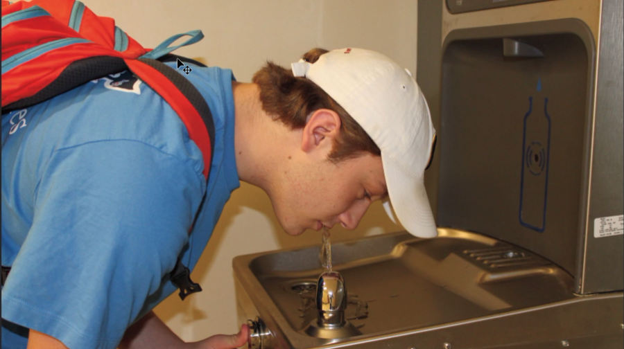 Senior Max Steinbaum drinks from a water fountain at Clayton High School. (Photo by Erin Castellano)