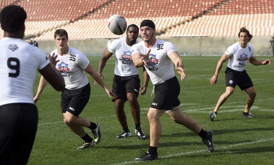 Jake Latimer, second from right, pitches the ball to a teammate while participating in a rugby combine at the Los Angeles Memorial Coliseum in Los Angeles on January 12, 2015. The National Rugby Football Leagues (NRFL) is recruiting U.S. football players for the new league that plans to start playing in the summer of 2016. (Mel Melcon/Los Angeles Times/TNS)