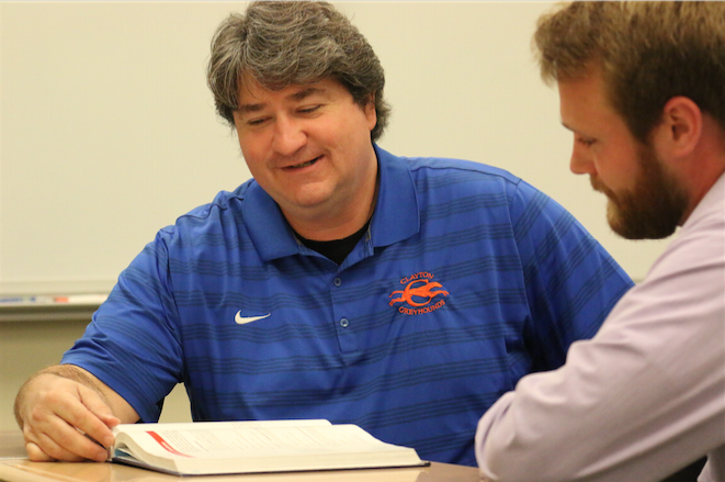 Mike Rust works with math teacher Alex Schwent.