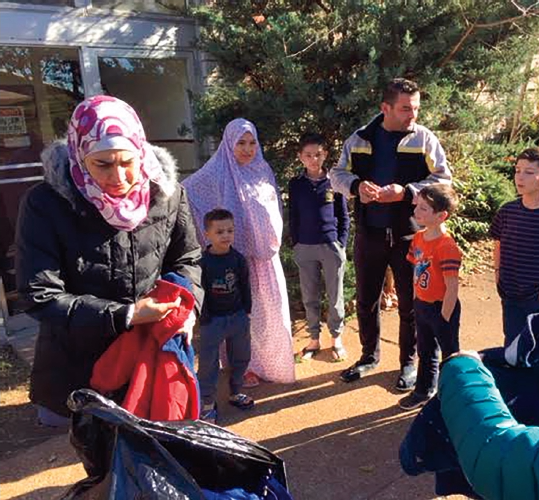 Syrian Refugees receiving coats from a coat drive in st. Louis