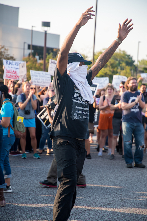 A protester in the crowd. Photo by Michael Melinger.