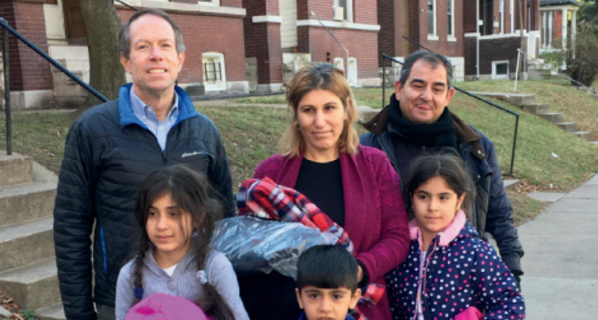 Photo of Charlie Brennan and a Syrian family.