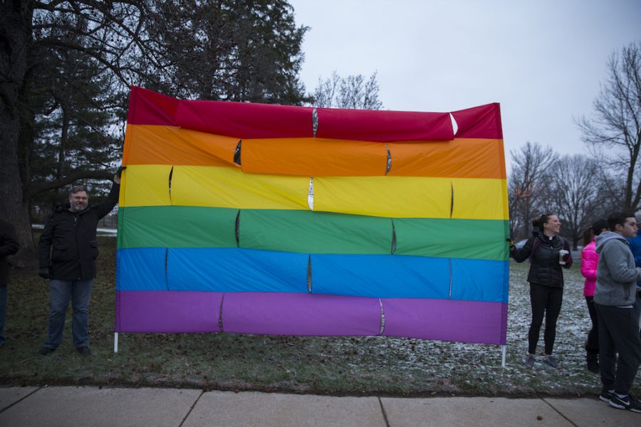 Members of the community hold up a ten foot flag during the protest.