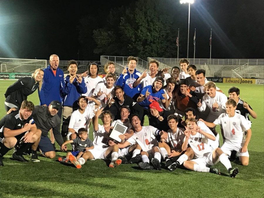 The hounds pose for a photo with their plaque after defeating Alton Marquette to win the CYC tournament and become the #1 ranked small school in St. Louis.