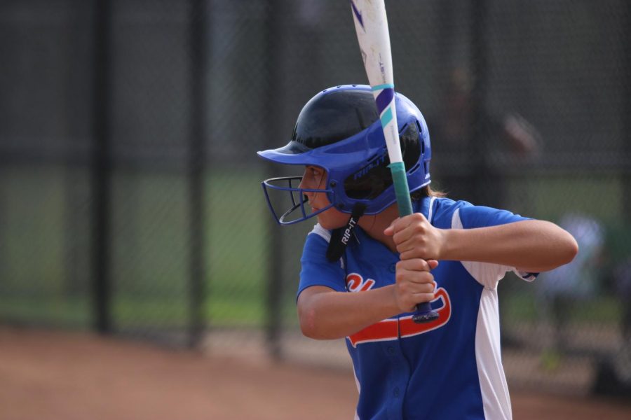 Sophomore Olivia Zindel prepares to swing in a girls varsity softball game.