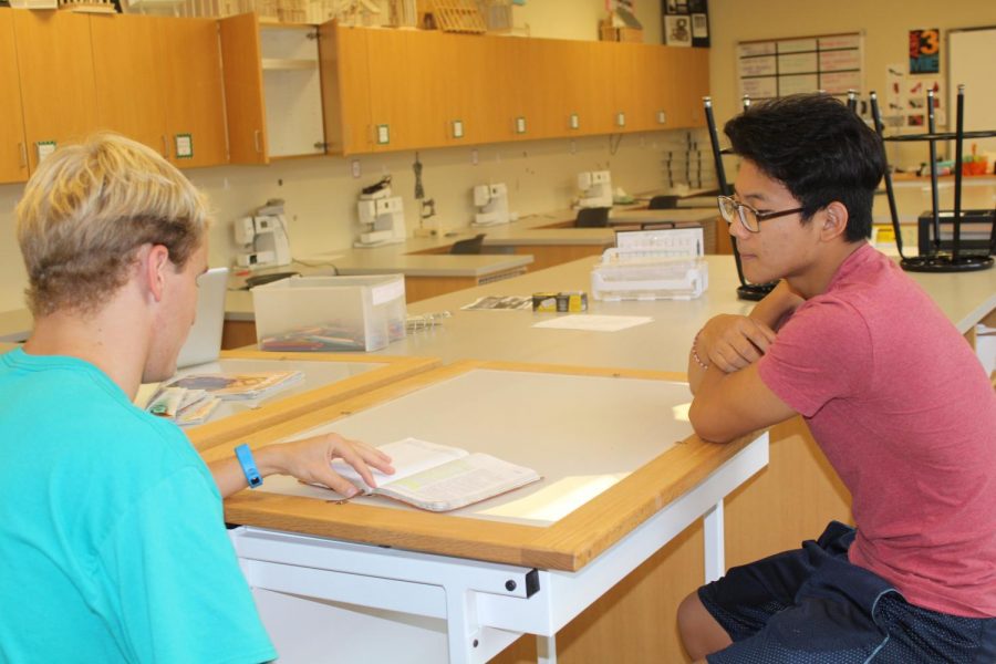 Senior Wil Welch discusses plans for the FCA with a fellow student.