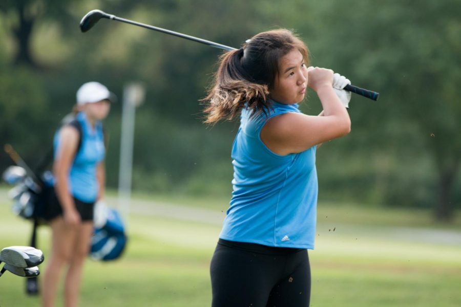 Senior Liz Wong hits the ball while playing with the Greyhounds at a girls' varsity golf tournament. The team's bus was hit by a car on I-170 on the way to practice.