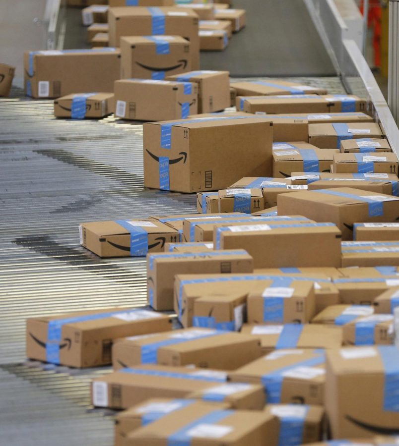 Boxes move towards trucks at an Amazon Fulfillment Center in Haslet,Texas.