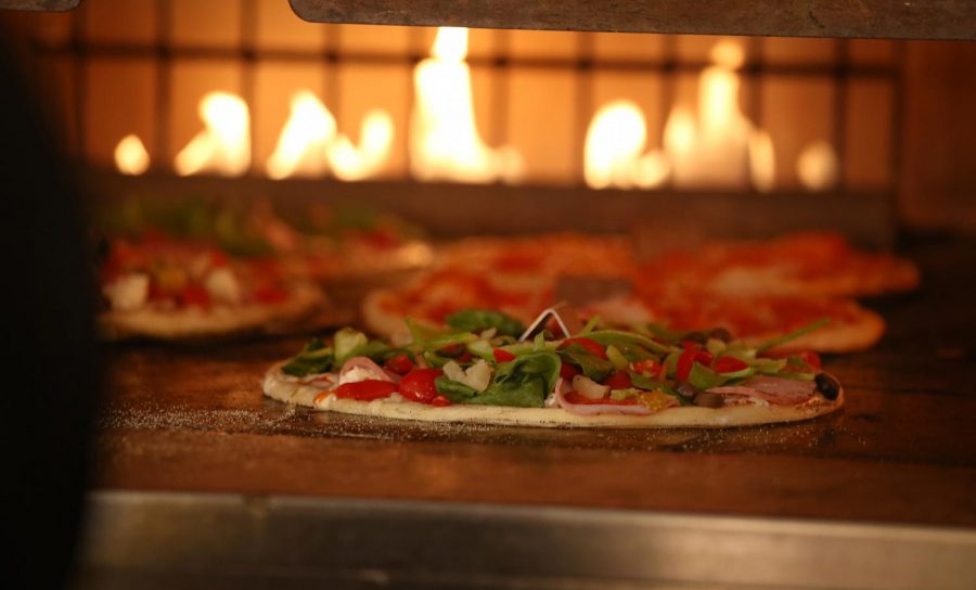 Blaze Pizza differentiates itself from traditional pizza chains with its ovens, promising custom pies with short waits. 