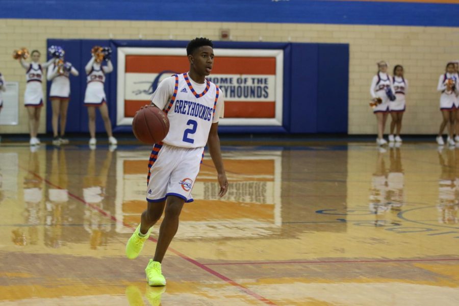 Senior Robert Hancock moves up the court with the ball during the 2017-18 season's Coaches vs. Cancer game against Ladue.