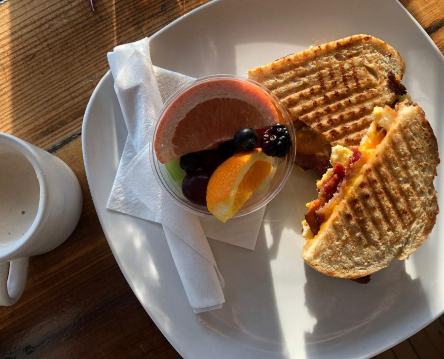 Lola Jean's "Sunrise" breakfast sandwich comes with egg, bacon, and cheese on a toasted sourdough bun.